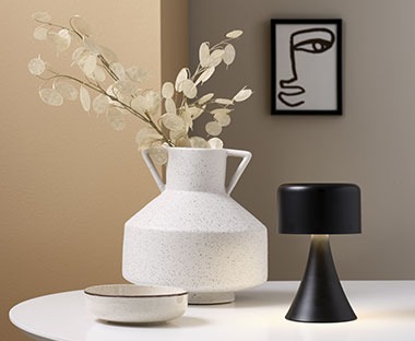 Kameninová váza v bielej farbe a čierna lampa