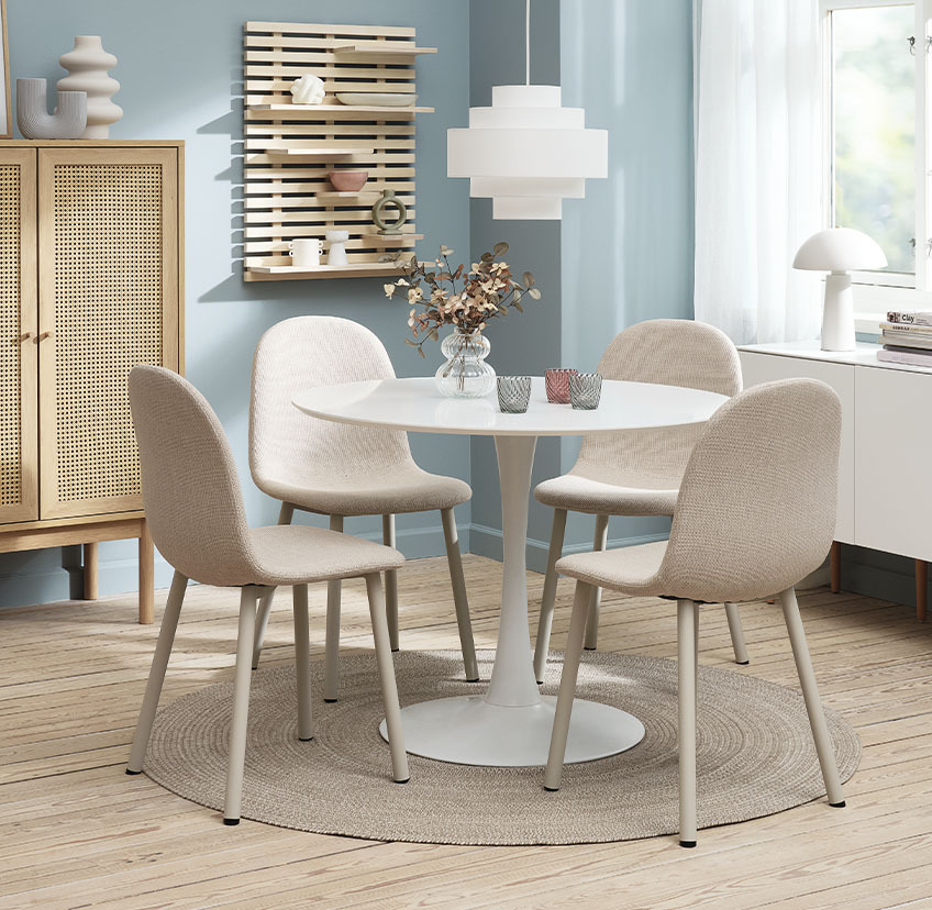 Light beige dining chairs and round dining table in white 