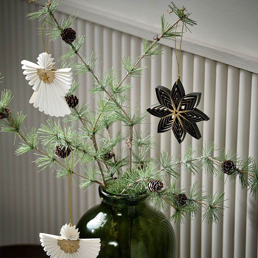 Artificial fir twig with fir cones and Scandinavian Christmas décor