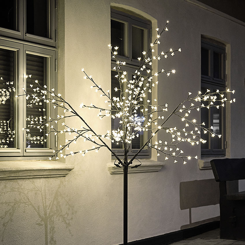 Large LED light tree illuminating house 