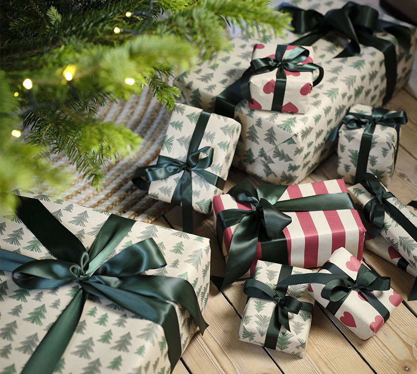 Christmas gifts decorated with Christmas baubles, twigs, and pine cones