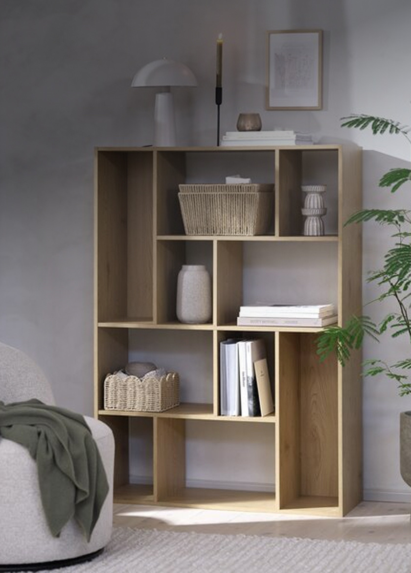 Bookcases Black-framed glass display cabinet with wood-backed shelves holding glassware, bowls, and woven storage baskets, beside a potted plant and framed art.