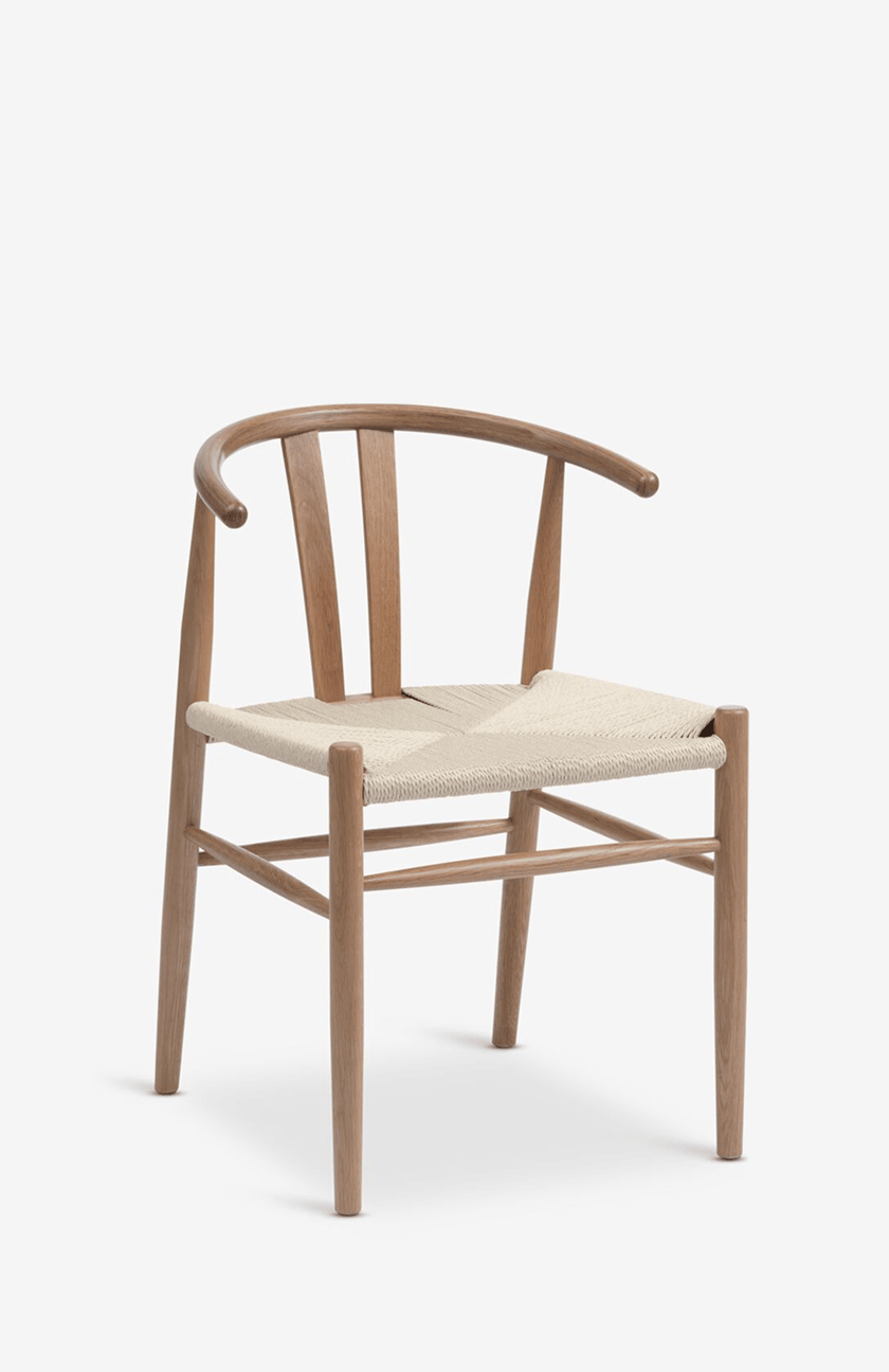 Oak wishbone-style dining chair with a curved backrest and a woven paper cord seat, shown against a plain white background.