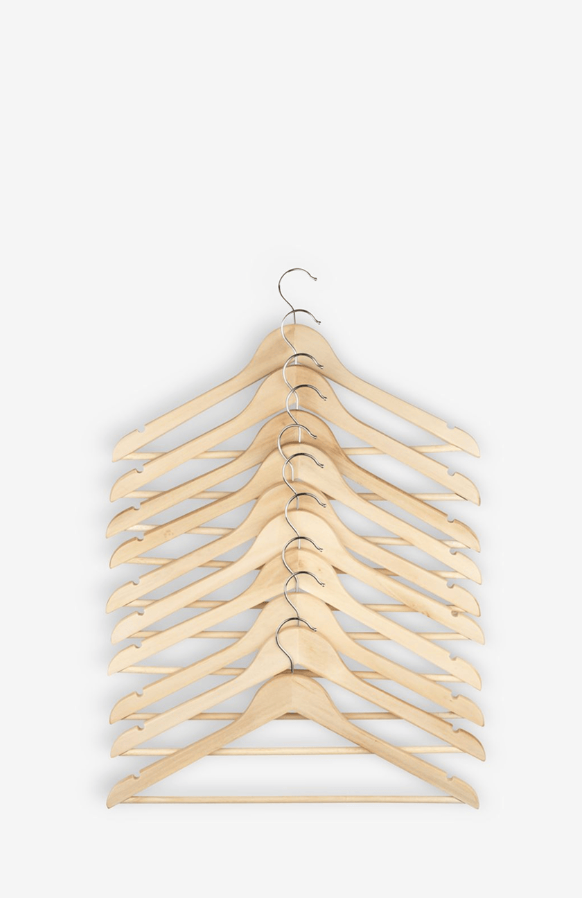 Hangers Stack of natural wood clothing hangers with chrome hooks, viewed from above.