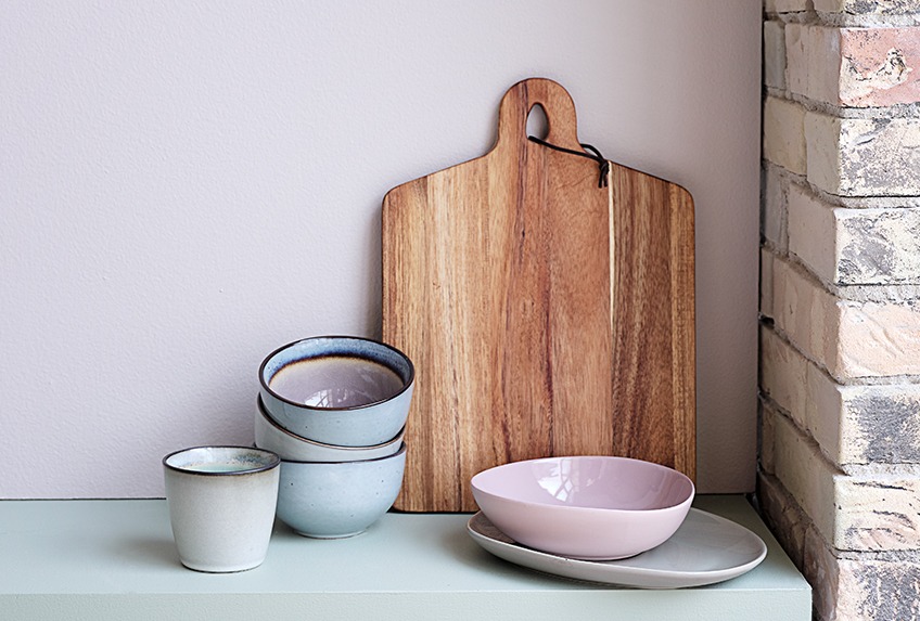 Table with bowls, plates, cups and cutting board