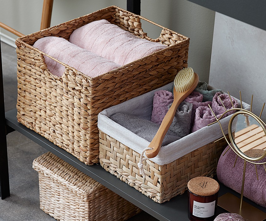 STIDSVIG and TORSBY towels organised in BJORN and EJNO baskets Nicely folded towels in wicker storage baskets on a shelf