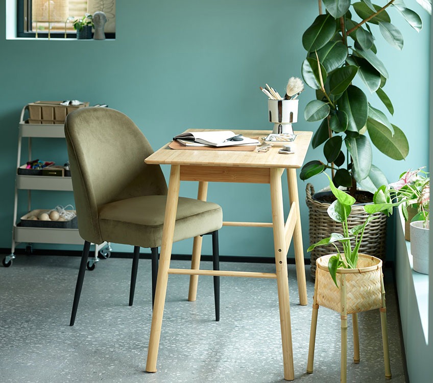 Olive green dining chair by a desk in bamboo