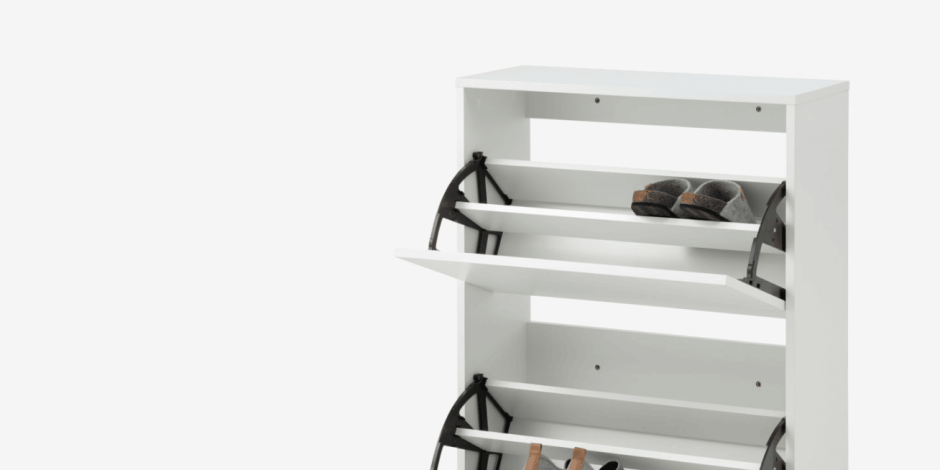Shoe storage White shoe cabinet with tilting drawers holding slippers and shoes, shown against a plain white background.
